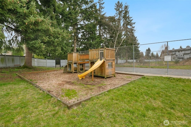 view of jungle gym with a lawn and fence