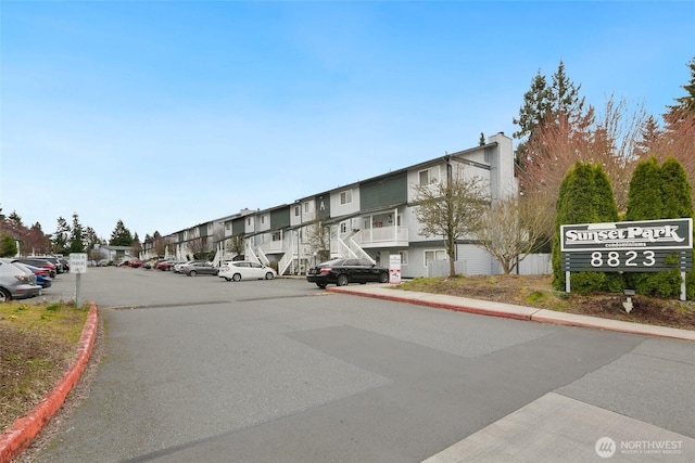 view of road featuring a residential view, curbs, and sidewalks