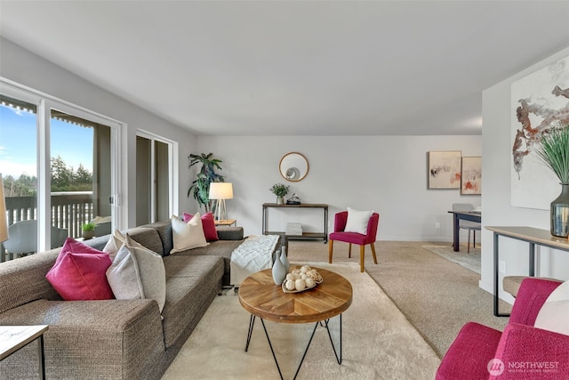 living room featuring light colored carpet and baseboards