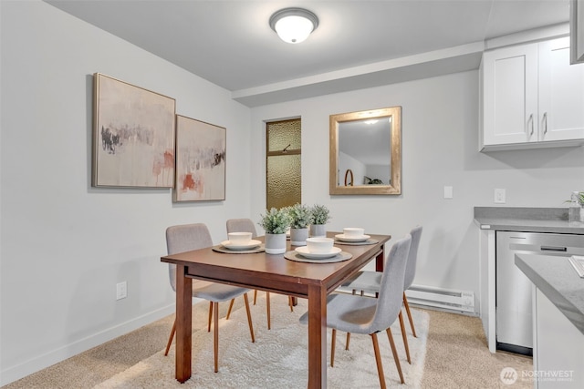 dining space featuring light colored carpet, baseboards, and baseboard heating