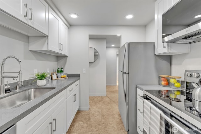 kitchen with a sink, white cabinetry, recessed lighting, stainless steel appliances, and baseboards