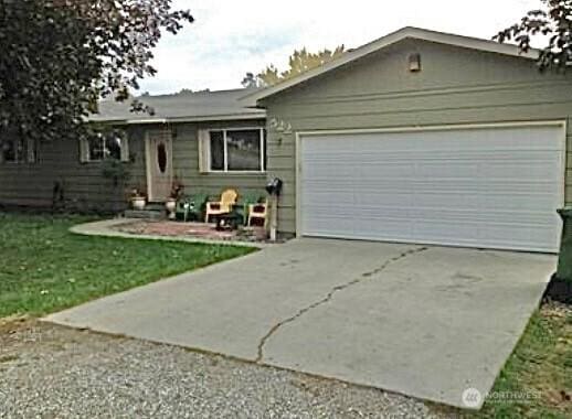 ranch-style house with a garage and driveway