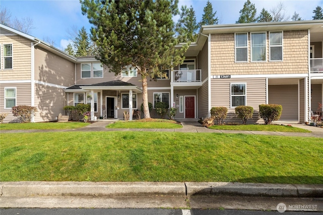 12601 172nd St E Unit Jj102, Puyallup, WA 98374 - view of front of property with a front lawn and a balcony