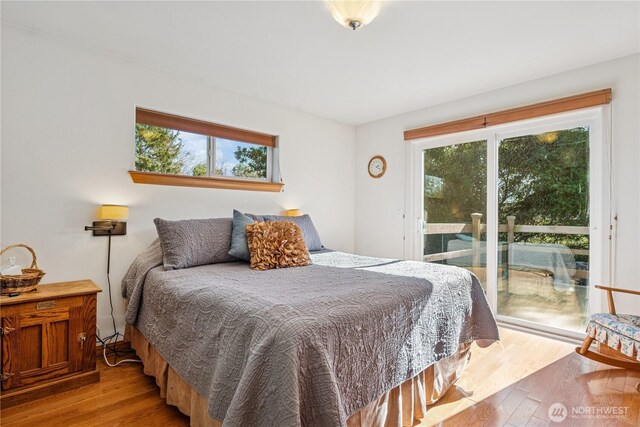 bedroom featuring light wood-style flooring and access to outside