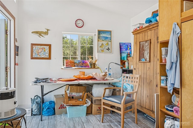 dining room featuring vaulted ceiling and wood finished floors