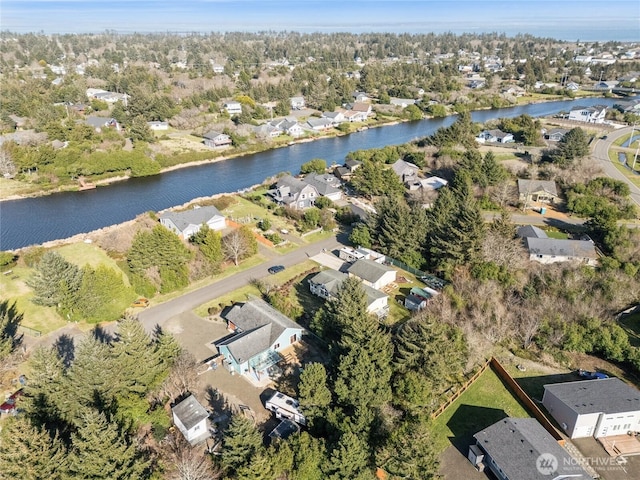 birds eye view of property with a residential view and a water view