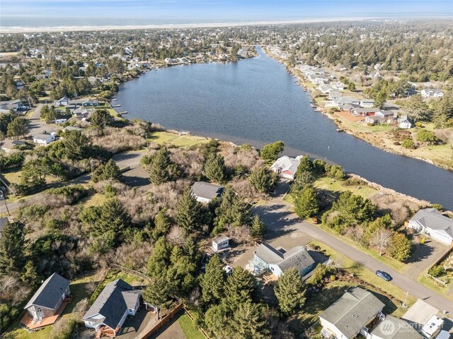 drone / aerial view with a residential view and a water view