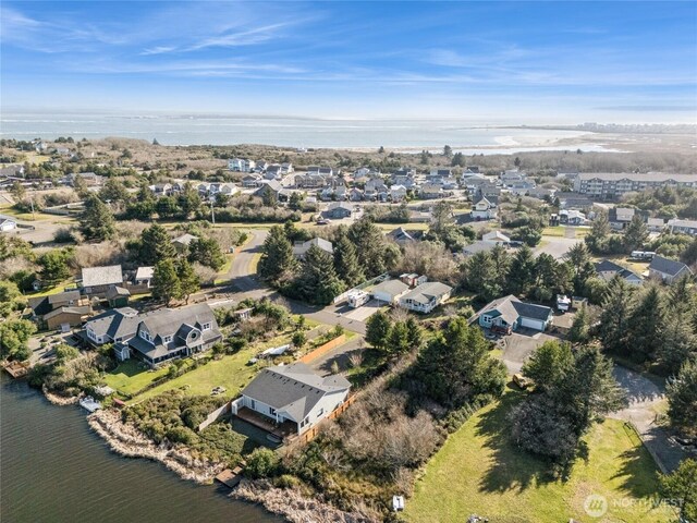 drone / aerial view with a water view and a residential view