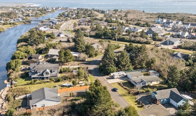 drone / aerial view with a residential view and a water view