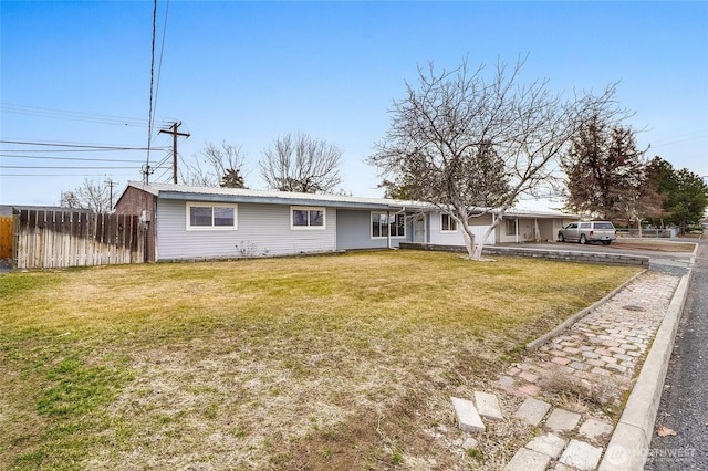 ranch-style house featuring metal roof, a front yard, and fence