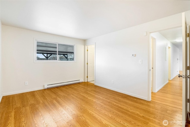 unfurnished room featuring light wood-style floors, baseboards, and baseboard heating