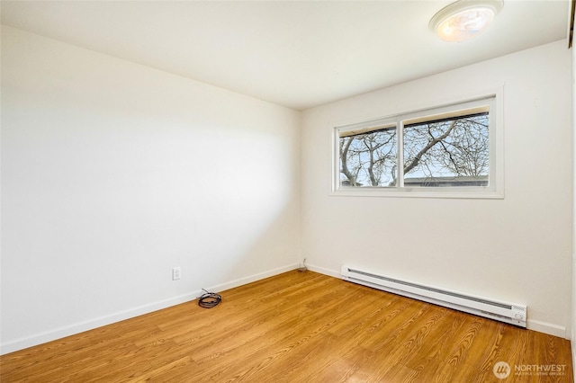 unfurnished room featuring light wood-type flooring, a baseboard radiator, and baseboards