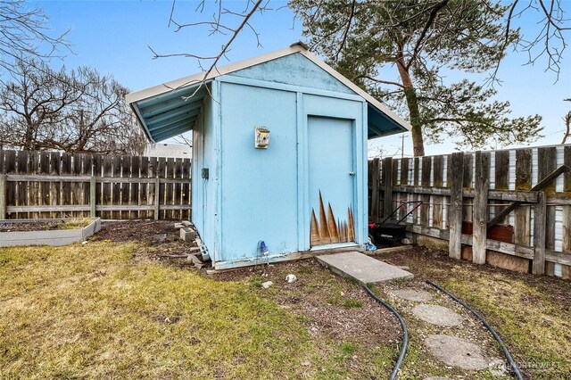 view of shed featuring a vegetable garden and a fenced backyard