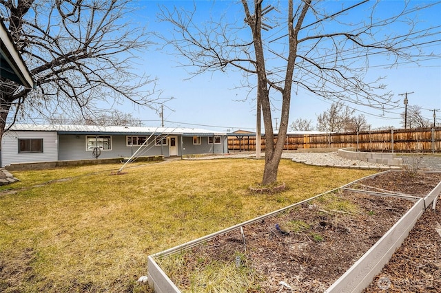 view of yard with a fenced backyard and a garden