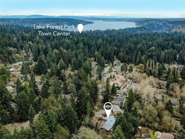 aerial view with a forest view and a water view