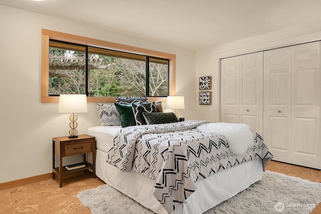 bedroom featuring a closet and baseboards