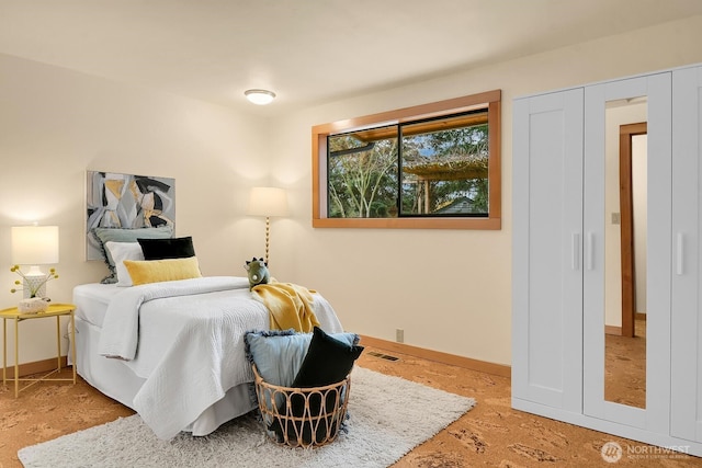 bedroom featuring visible vents and baseboards