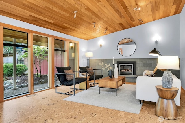 living area featuring visible vents, carpet, wooden ceiling, a fireplace, and lofted ceiling