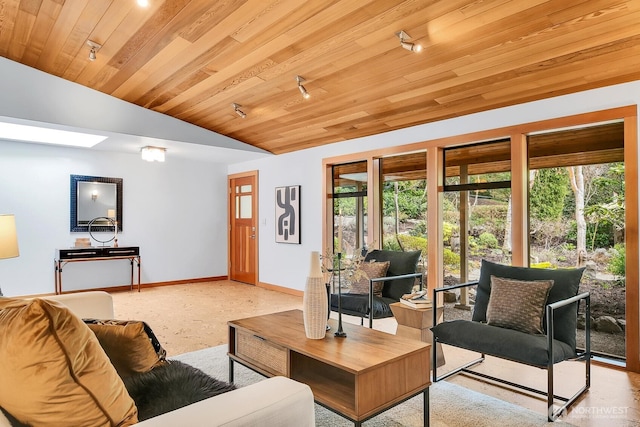 living room featuring vaulted ceiling with skylight, wood ceiling, and baseboards