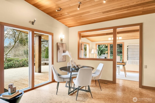 dining area with a wealth of natural light, wood ceiling, baseboards, and vaulted ceiling