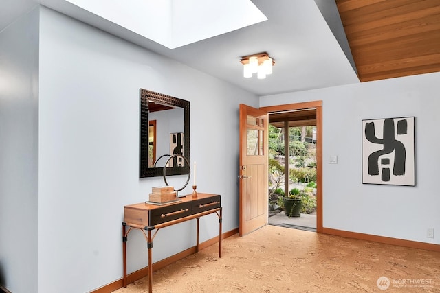 entrance foyer with a skylight and baseboards