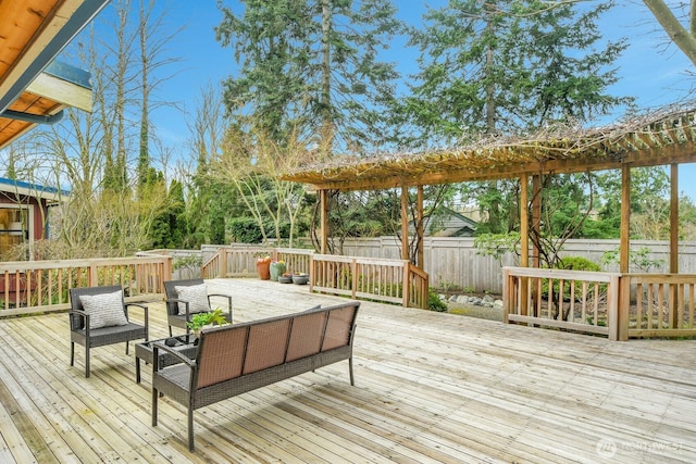 wooden terrace with an outdoor living space and fence