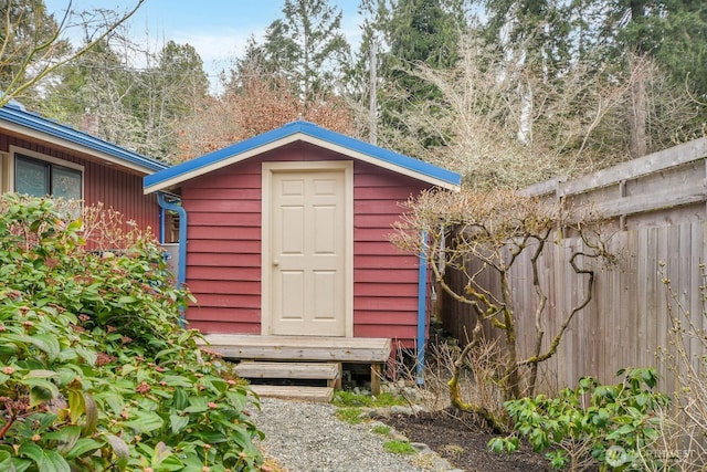 view of shed featuring fence