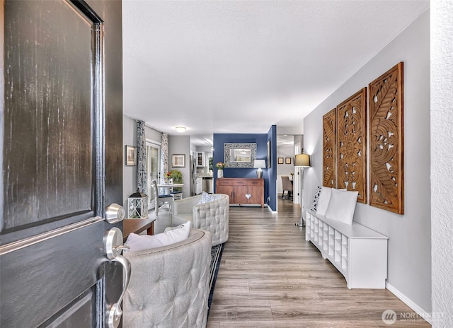 living room with baseboards and wood finished floors