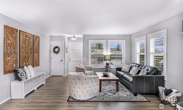 living area with wood finished floors and baseboards