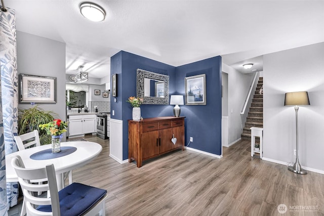 interior space with stairway, baseboards, and wood finished floors