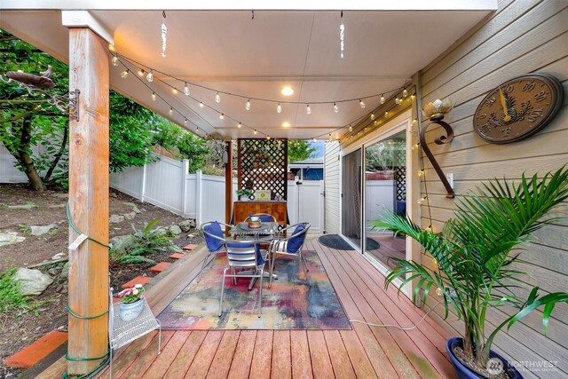 deck with outdoor dining space and fence