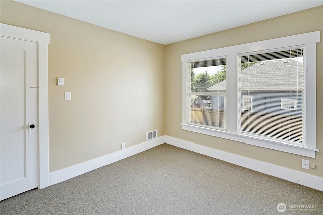 spare room with visible vents, carpet floors, and baseboards