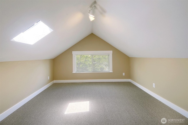 bonus room featuring vaulted ceiling, carpet flooring, and baseboards