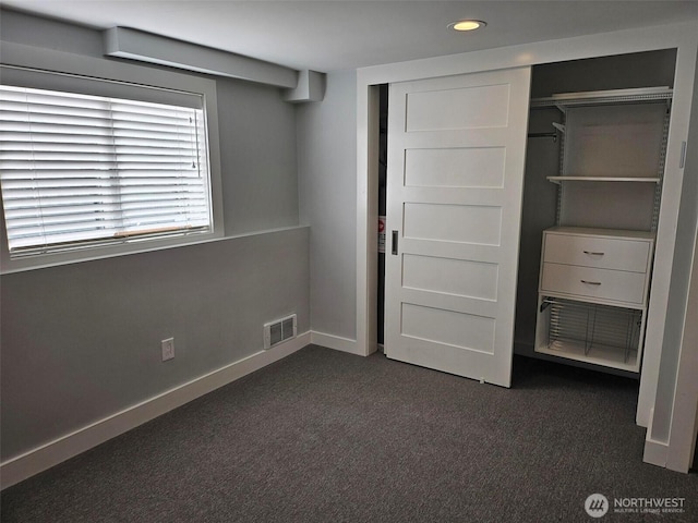 unfurnished bedroom featuring visible vents, dark carpet, recessed lighting, a closet, and baseboards