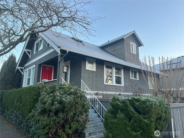 view of front of home featuring roof with shingles