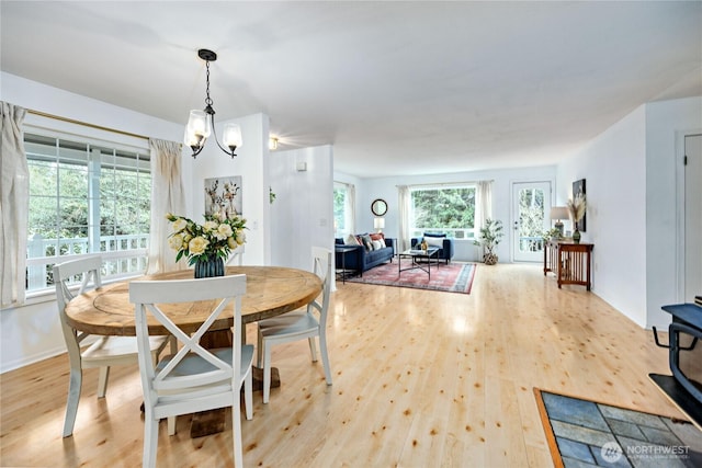 dining area featuring wood finished floors and a chandelier