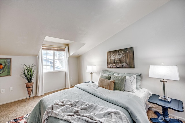 carpeted bedroom with baseboards and lofted ceiling