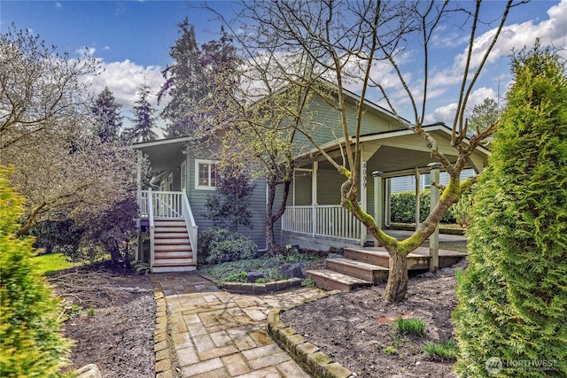 view of front of home with a porch and stairs