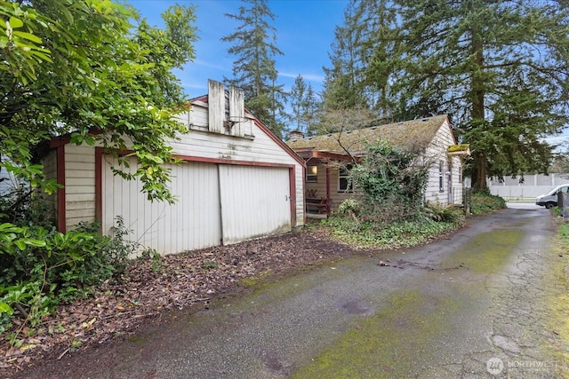 exterior space with a detached garage and fence