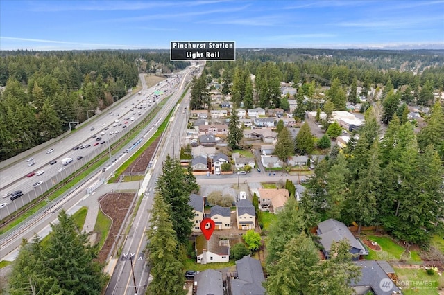 birds eye view of property featuring a view of trees