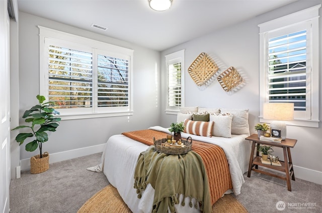 bedroom featuring visible vents, carpet floors, and baseboards