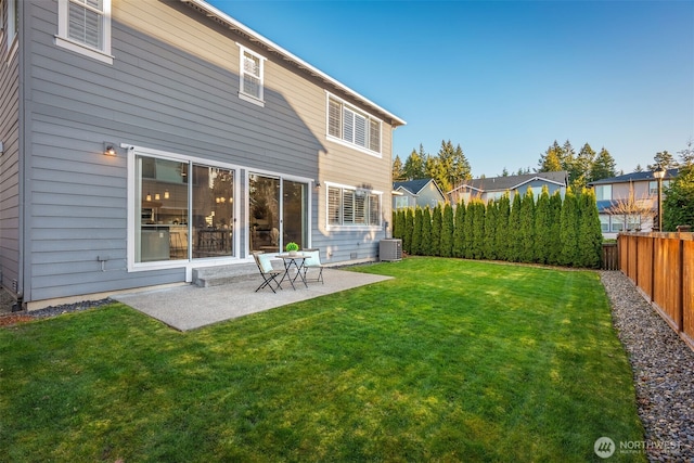 rear view of house with central air condition unit, a patio, a yard, and fence