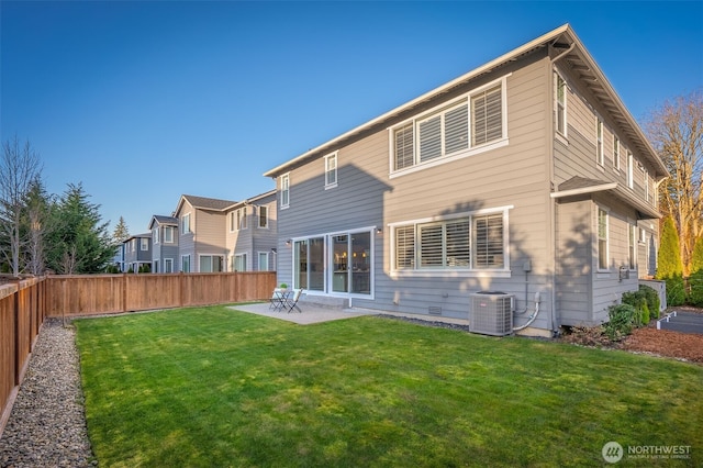 rear view of house featuring a lawn, a patio, a fenced backyard, cooling unit, and crawl space