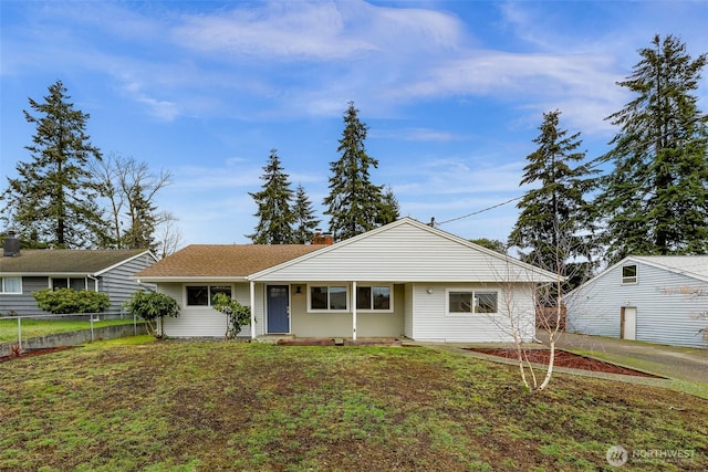 ranch-style house featuring a front lawn and fence