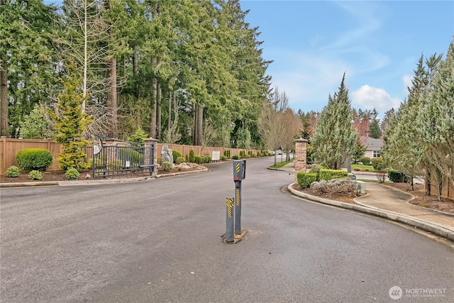 view of street featuring curbs and a gated entry