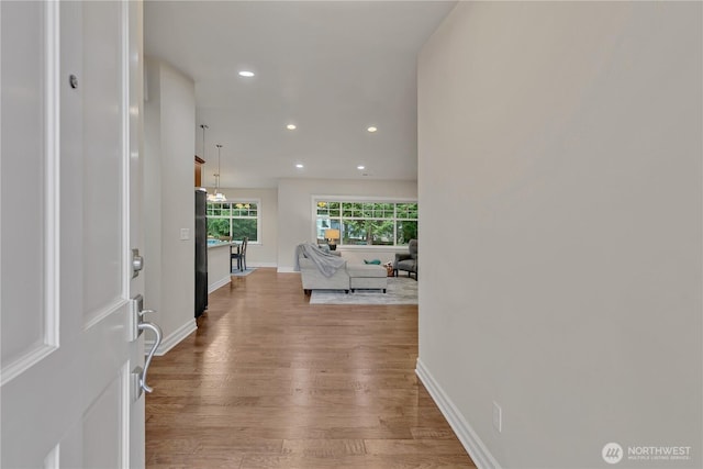 entryway with recessed lighting, baseboards, and wood finished floors