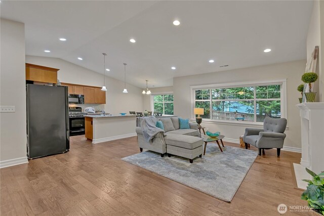 living area featuring recessed lighting, light wood-style flooring, baseboards, and lofted ceiling