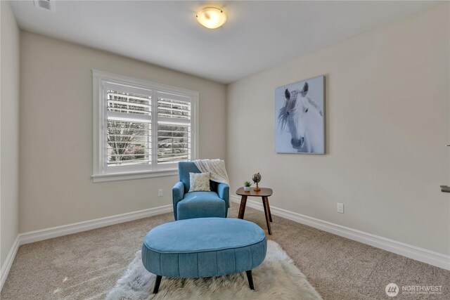 sitting room with baseboards and carpet floors