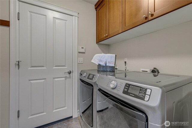 washroom featuring cabinet space and independent washer and dryer