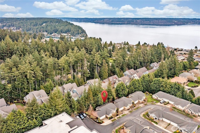 birds eye view of property featuring a residential view, a view of trees, and a water view